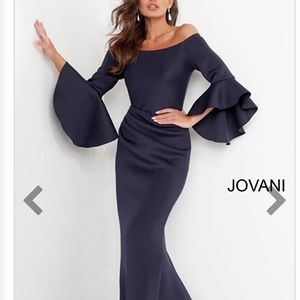 JOVANI SCUBA GOWN OFF SHOULDER IN A BEAUTIFUL DARK NAVY BLUE WITH BELL SLEEVES.